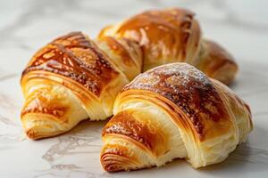 Three Freshly Baked Croissants with Golden Crusts photo