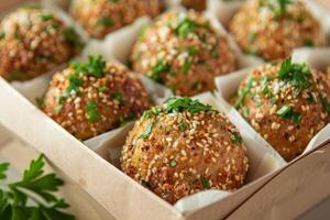 Sesame-Crusted Meatballs with Parsley Garnish in a Wooden Box photo