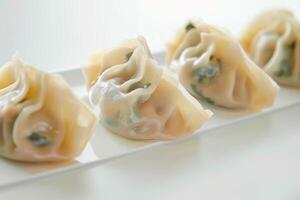 Four Steamed Dumplings on a White Plate photo