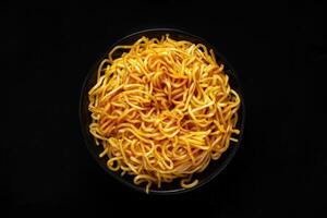 Close-up of a Bowl of Cooked Noodles on a Black Background photo