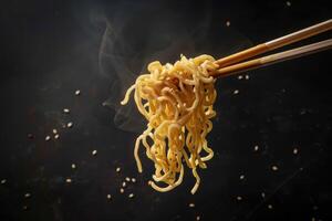 Steaming Noodles Held by Chopsticks Against a Black Background photo