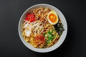 Bowl of Ramen Noodles with Egg, Bean Sprouts, and Seaweed photo