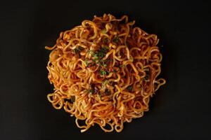 Close-up of Spicy Noodles with Green Onions and Spices photo