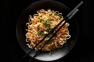 Noodles with Green Onions in a Black Bowl with Chopsticks photo
