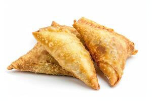 Three Golden Brown Fried Samosas on a White Background photo