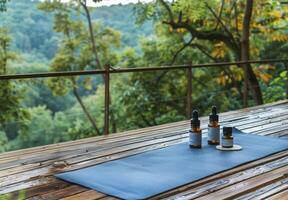 A serene nature scene featuring a yoga mat and essential oils set up on a wooden deck overlooking a peaceful forest, symbolizing holistic health and wellness photo