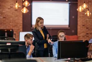 Strategic Business Meeting. Group of Professionals Collaborating in Office Using Computers photo