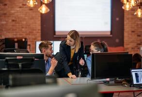 Strategic Business Meeting. Group of Professionals Collaborating in Office Using Computers photo