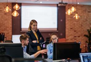 Strategic Business Meeting. Group of Professionals Collaborating in Office Using Computers photo