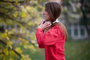 Athletic young woman taking a breath and relaxing after jogging and stretching. Woman Training and Workout Exercises On Street. photo