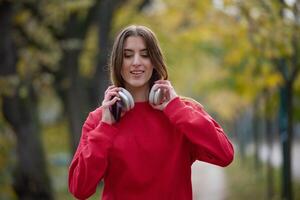 Athletic young woman taking a breath and relaxing after jogging and stretching. Woman Training and Workout Exercises On Street. photo
