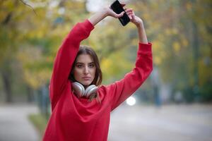 Athletic young woman taking a breath and relaxing after jogging and stretching. Woman Training and Workout Exercises On Street. photo