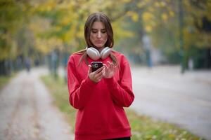 Athletic young woman taking a breath and relaxing after jogging and stretching. Woman Training and Workout Exercises On Street. photo