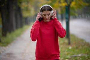 Athletic young woman taking a breath and relaxing after jogging and stretching. Woman Training and Workout Exercises On Street. photo