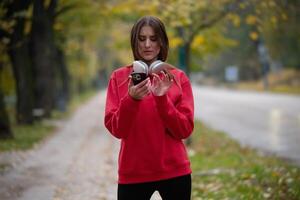 Athletic young woman taking a breath and relaxing after jogging and stretching. Woman Training and Workout Exercises On Street. photo