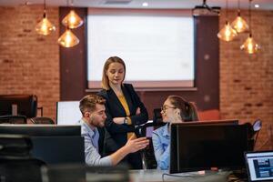 Strategic Business Meeting. Group of Professionals Collaborating in Office Using Computers photo