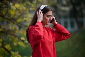 Athletic young woman taking a breath and relaxing after jogging and stretching. Woman Training and Workout Exercises On Street. photo