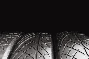 Car tire row isolated on black background with copy space for text , Old car tire with scratch , Car tire concept photo