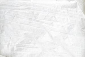 Abstract White Bedding Sheets or White wrinkled fabric background texture and Texture with copy-space Creased or wrinkled white fabric,Soft focus photo