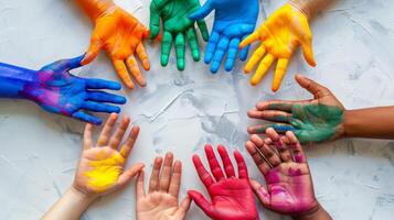 Diverse hands painted in vibrant colors arranged in a circle, symbolizing creativity, unity, and diversity in a playful and artistic manner. photo