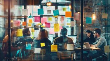 A team of professionals brainstorming ideas with colorful sticky notes in a modern, creative office environment, collaborating on laptops. photo
