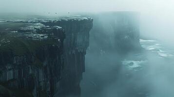 Dramatic mist-covered cliffs rise above stormy ocean waves, creating a mysterious and atmospheric seascape. photo