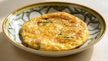 Golden herb and cheese omelette served on a decorative plate, perfect for a nutritious and flavorful breakfast or brunch. photo