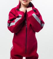 Child in red jumpsuit with grey stripes photo