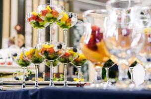 Glasses with Vegetable Salad on Buffet Table photo