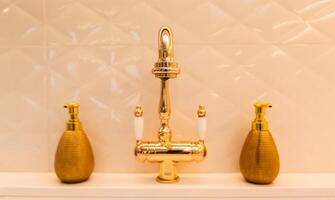 Gold Faucet with Soap Dispensers in Kitchen photo