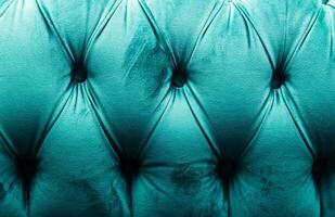 Turquoise Velvet Tufted Sofa Close-Up with Elegant Pattern photo