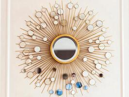 Decorative Sunburst Mirror with Metallic Gold Frame and Circles photo