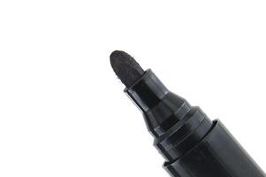 Close-up of black permanent marker with white background for office and art use photo