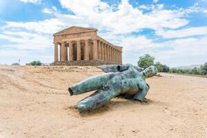 Agrigento, Italy-May 10, 2022-The Temple of Concordia and fallen Icarus inside the valley of the temples, an archaeological park near Agrigento during a sunny day photo