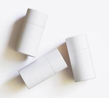 White Paper tube package mockups isolated on white background. Blank craft carton circular realistic tube texture. Cylindrical container with cap for product branding photo