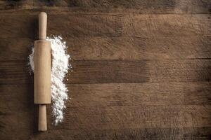 Rolling pin and flour on wooden board photo