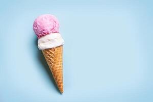 Ice Cream Scoops in Cone on blue background photo