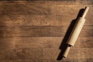 Rolling pin on wooden board photo
