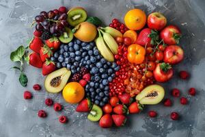 Top view of various fruits in heart shape on grey kitchen table. photo