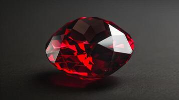 CloseUp Photograph of a Single Polished Garnet Highlighting its Intricate Facets and Rich Red Color Against a Dark Background photo