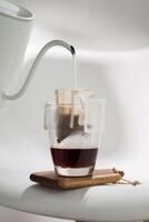 A Drip Bag methodically filters water through Coffee grounds, exemplifying precision in brewing techniques. photo
