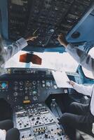 Professional pilot woman in uniform has teamwork meeting for success flight in aviation business. Young female captain instructor sitting in office and working or training commercial airline crew. photo