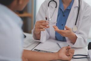 Doctor uses hypodermic needle and syringe to put a dose of medicine as treatment. photo