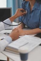 Doctor using a stethoscope checking patient with examining, presenting results symptom and recommend treatment method, Healthcare and medical concept. photo