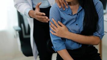Doctor or Physiotherapist working examining treating injured arm of athlete male patient, stretching and exercise, Doing the Rehabilitation therapy pain in clinic. photo