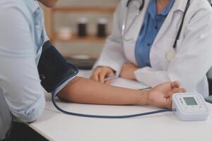 The doctor woman hand use the pulse meter to measure the pressure of the patient, medical checkup concept. photo