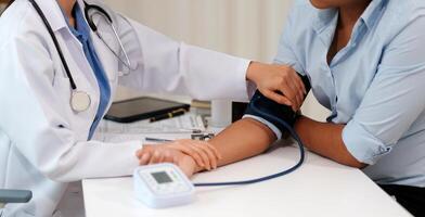 The doctor woman hand use the pulse meter to measure the pressure of the patient, medical checkup concept. photo