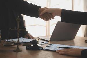 concept of justice and law A male judge in the courtroom on a wooden table and a male counselor or lawyer working in the office. Law, advice and justice concepts. photo