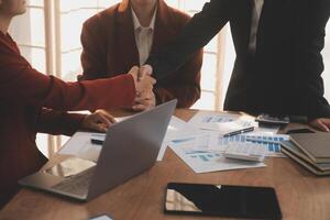 Close up of a team of business people having a meeting to analyze data for a marketing plan. photo
