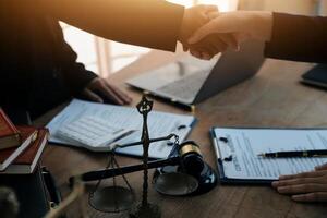 concept of justice and law A male judge in the courtroom on a wooden table and a male counselor or lawyer working in the office. Law, advice and justice concepts. photo